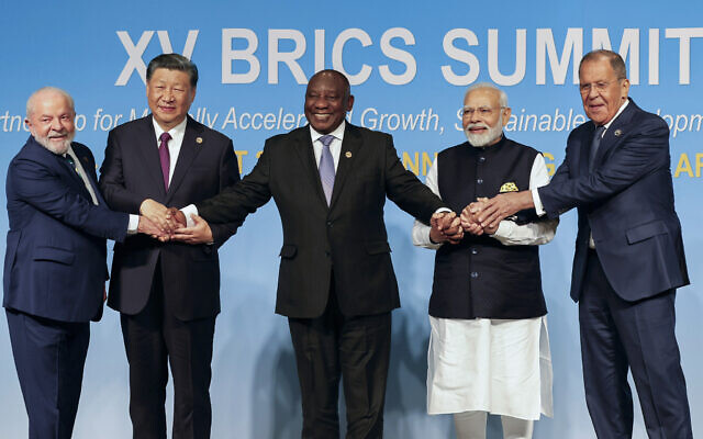 From left, Brazil's President Luiz Inacio Lula da Silva, China's President Xi Jinping, South Africa's President Cyril Ramaphosa, India's Prime Minister Narendra Modi and Russia's Foreign Minister Sergei Lavrov pose for a BRICS group photo during the 2023 BRICS Summit in Johannesburg, South Africa, Aug. 23, 2023. (Gianluigi Guercia/Pool via AP)