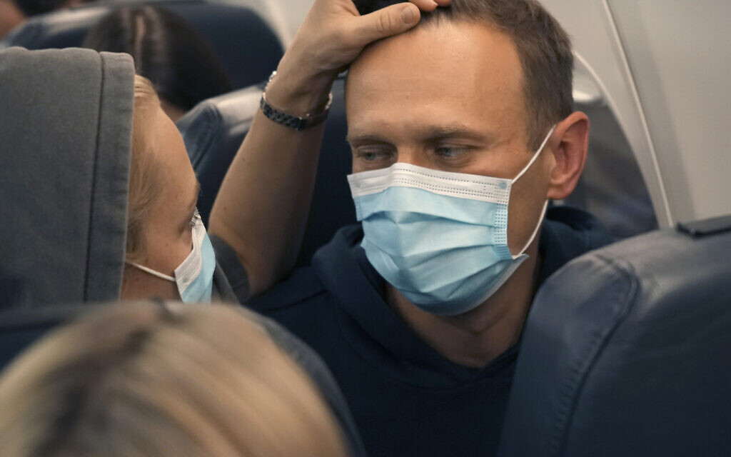 Alexei Navalny and his wife Yulia sit on the plane on a flight to Moscow, at the Airport Berlin Brandenburg (BER) in Schoenefeld, near Berlin, Germany, Sunday, Jan. 17, 2021. (AP/Mstyslav Chernov)