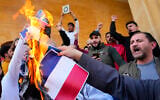 Scores of angry protesters burn the Swedish and Netherlands flags after Friday prayers outside Mohammad al-Amin Mosque to denounce the recent desecration of Islam's holy book by activists in the European countries in downtown Beirut, Lebanon, January 27, 2023. (AP Photo/Hassan Ammar, File)