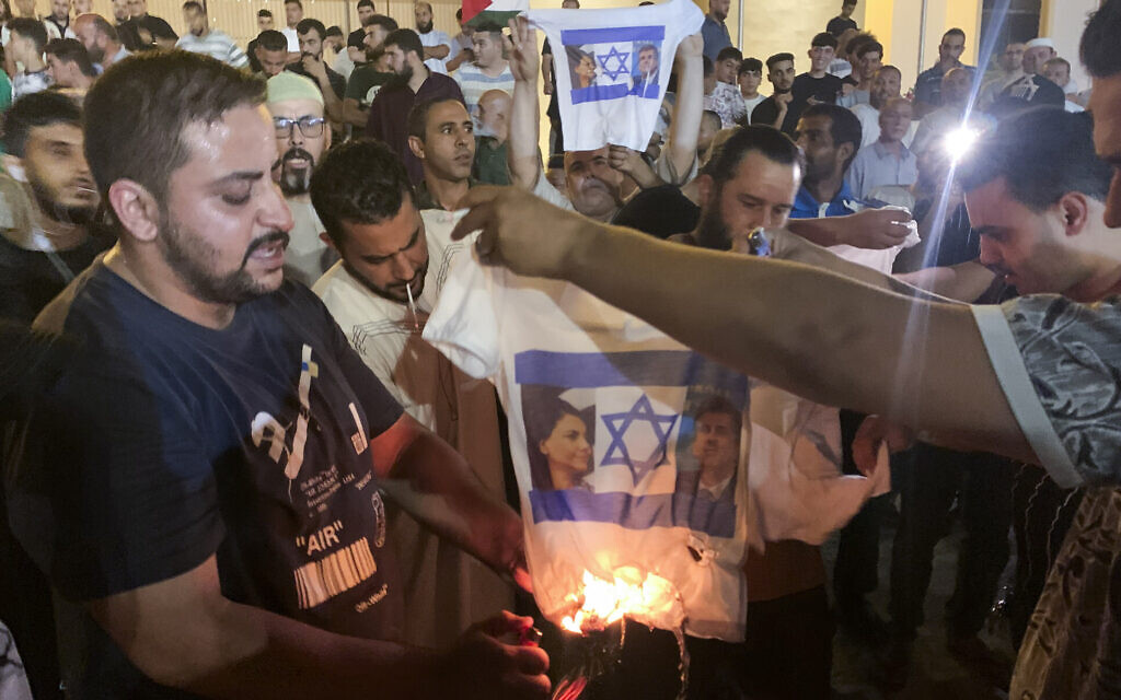 Libyans burn a shirt showing an Israeli flag, Foreign Minister Eli Cohen and his Libyan counterpart Najla Mangoush, in Tripoli, Libya, August 27, 2023. (AP Photo/Yousef Murad) Libyans burn a shirt showing an Israeli flag, Foreign Minister Eli Cohen and his Libyan counterpart Najla Mangoush, in Tripoli, Libya, August 27, 2023. (AP Photo/Yousef Murad)