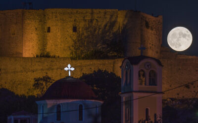The supermoon rises behind the Chlemoutsi medival castle in Kyllini, Peloponnese, Greece, August 30, 2023. (Petros Giannakouris/AP)