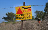 Illustrative: A warning sign of a mine field near the Israeli-Syrian border in the Golan Heights, August 20, 2021. (Michael Giladi/Flash90)
