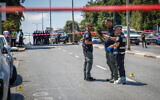 Illustrative: Forensic examiners investigate the crime scene where a man was shot and killed, in Haifa, July 6, 2023. (Shir Torem/Flash90)