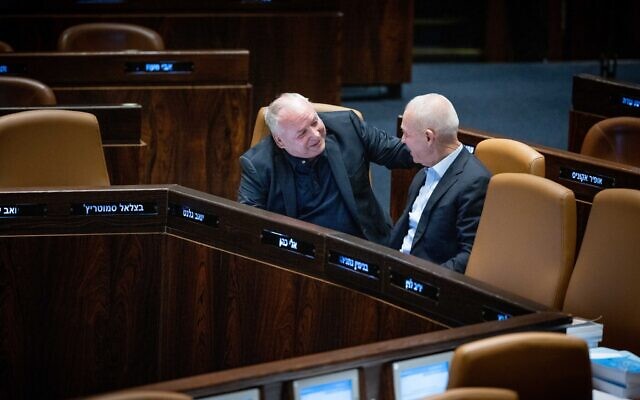 Defense Minister Yoav Gallant, right, talks with Regional Cooperation  Minister David Amsalem, during a plenum session at the Knesset in Jerusalem on July 10, 2023. (Yonatan Sindel/Flash90)