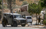 Israeli soldiers near the scene of a terror shooting in the Jordan Valley on August 2, 2023. (Nasser Ishtayeh/Flash90)
