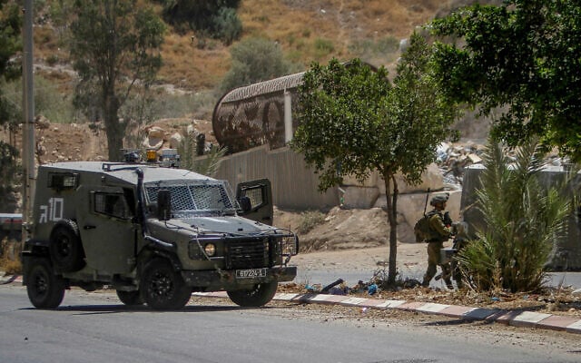 IDF soldiers near the scene of a shooting attack in the Jordan Valley in the West Bank, on August 2, 2023. (Nasser Ishtayeh/Flash90) IDF soldiers near the scene of a shooting attack in the Jordan Valley in the West Bank, on August 2, 2023. (Nasser Ishtayeh/Flash90)