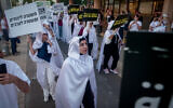 Members of the Arab community holding hundreds of fake coffins as they protest against the violence in their community, at Habima Square in Tel Aviv on August 6, 2023 (Photo by Avshalom Sassoni/Flash90)