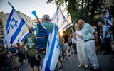 Anti-overhaul activists protest against the judicial overhaul outside the home of Minister of Strategic Affairs Ron Dermer in Jerusalem on August 10, 2023. (Yonatan Sindel/Flash90)