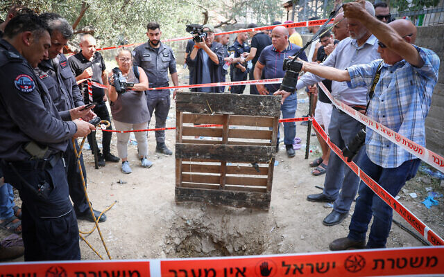 Police and rescue personnel at the scene where three people fell into an eight-meter-deep pit in Deir El Asad, northern Israel on August 13, 2023. (David Cohen/Flash90) Police and rescue personnel at the scene where three people fell into an eight-meter-deep pit in Deir El Asad, northern Israel on August 13, 2023. (David Cohen/Flash90)