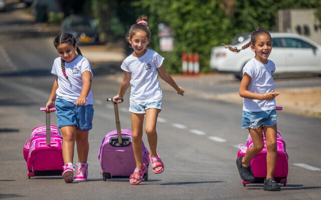 Israeli children who will begin 1st grade in the upcoming academic school year pose for a picture in Moshav Yashresh, August 23, 2023. (Yossi Aloni/Flash90)