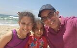 Liba (C) and Sara Goldschmidt, who are suspected of being kidnapped by their mother during a trip in Israel, with their father Ofer. (Courtesy)