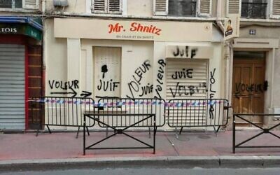 Antisemitic graffiti, reading "Jew" and "thief," on display on the facade of Mr. Schnitz, a popular kosher eatery near Paris, on Aug. 19, 2023. (Prefecture of the 92nd regional department, Hauts-de-Seine)