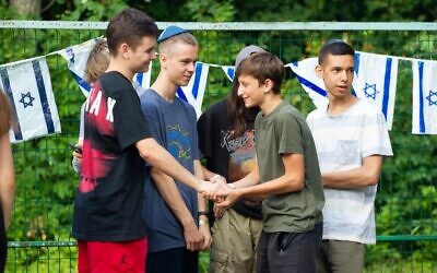 Campers at Ramah Ukraine greet each other after returning to camp for the first session in the country during wartime. (Courtesy Midreshet Schechter via JTA)