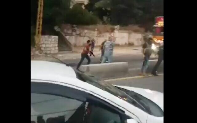 A screen capture of social media video from the Lebanese town of Kahale shows gunman during clashes in the Lebanese town of between Hezbollah members and local residents, August 9, 2023. (screen capture: Twitter; used in accordance with Clause 27a of the Copyright Law) A screen capture of social media video from the Lebanese town of Kahale shows gunman during clashes in the Lebanese town of between Hezbollah members and local residents, August 9, 2023. (screen capture: Twitter; used in accordance with Clause 27a of the Copyright Law)