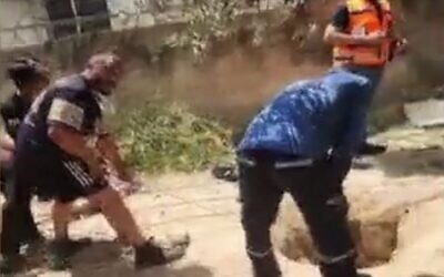Police and rescue personnel try to extract two firefighters and another man from a hole into which they fell, in the northern village of Deir al-Asad, August 13, 2023. (screenshot used in accordance with Clause 27a of the Copyright Law))