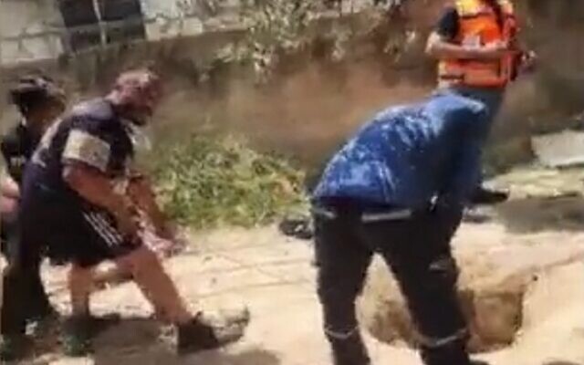 Police and rescue personnel try to extract two firefighters and another man from a hole into which they fell, in the northern village of Deir al-Asad, August 13, 2023. (screenshot used in accordance with Clause 27a of the Copyright Law)) Police and rescue personnel try to extract two firefighters and another man from a hole into which they fell, in the northern village of Deir al-Asad, August 13, 2023. (screenshot used in accordance with Clause 27a of the Copyright Law))