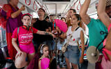 Anti-government protesters chain themselves to a train car during the opening of the light rail in Tel Aviv, August 18, 2023. (AP Photo/Ohad Zwigenberg)