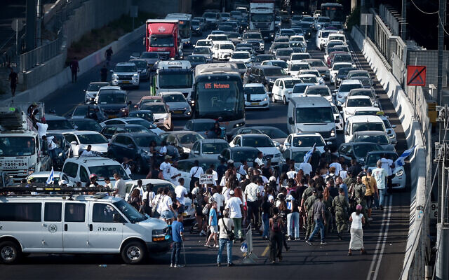 Members of the Ethiopian community and others block the Ayalon Highway in Tel Aviv, during a protest to demand justice for 4-year-old Rafael Adana, who was run over and killed in a car accident in Netanya, August 21, 2023. (Avshalom Sassoni/Flash90)