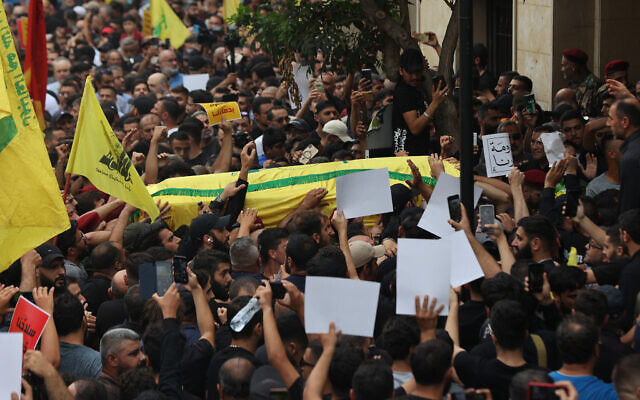 People carry the body of a member of the Lebanese terror group Hezbollah during his funeral in Beirut, on August 10, 2023. (Anwar Amro/AFP) People carry the body of a member of the Lebanese terror group Hezbollah during his funeral in Beirut, on August 10, 2023. (Anwar Amro/AFP)