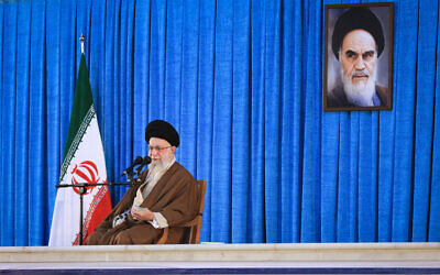 Illustrative: Iranian Supreme Leader Ayatollah Ali Khamenei speaks during a ceremony commemorating the death anniversary of the late revolutionary founder Ayatollah Khomeini, shown in the poster, at his mausoleum just outside Tehran, Iran, June 4, 2023. (Office of the Iranian Supreme Leader via AP)