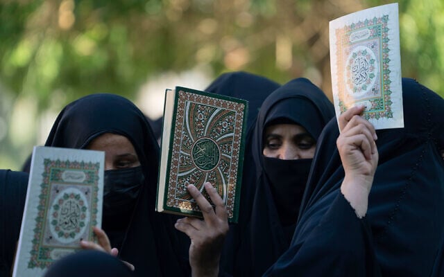 Illustrative: Iraqis raise copies of the Quran during a protest after reports of Quran burnings in Europe, in Baghdad, Iraq, July 22, 2023. (AP Photo/Hadi Mizban) Illustrative: Iraqis raise copies of the Quran during a protest after reports of Quran burnings in Europe, in Baghdad, Iraq, July 22, 2023. (AP Photo/Hadi Mizban)