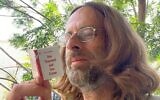 Writer Alex Epstein with one of his handmade miniature novels (Courtesy Alex Epstein)