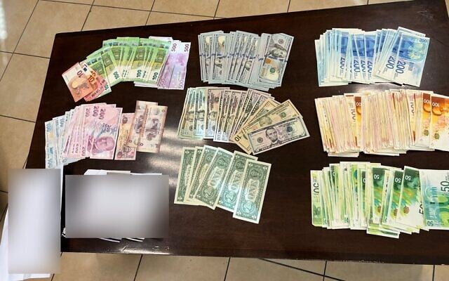 Cash seized for a suspect's home during a police investigation into the suspected extortion of a businessman, August 7, 2023. (Israel Police) Cash seized for a suspect's home during a police investigation into the suspected extortion of a businessman, August 7, 2023. (Israel Police)