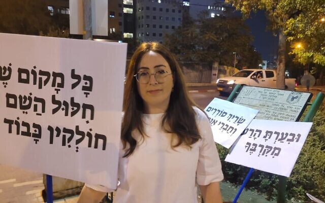 Fay Sukenik protest near the home of Meir Porush on Aug. 31, 2023 in Jerusalem, Israel over the cabinet minister's alleged assitance to a sex offender. Her sign reads: 'When God's name is desecrated by a rabbi, he is not worthy of respect.' (Courtesy of Sukenik) Fay Sukenik protest near the home of Meir Porush on Aug. 31, 2023 in Jerusalem, Israel over the cabinet minister's alleged assitance to a sex offender. Her sign reads: 'When God's name is desecrated by a rabbi, he is not worthy of respect.' (Courtesy of Sukenik)