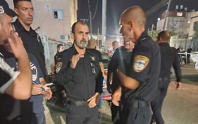 Police officers at the scene where a man was shot dead in a supermarket in Fureidis, August 31, 2023. (Israel Police)
