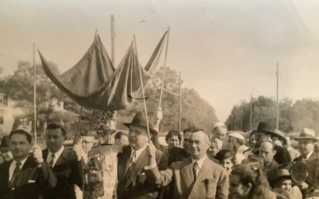 Congregants of Shairit Haplaite, a shtibl established by Holocaust survivor poultry farmers in Vineland, New Jersey, celebrate the arrival of a new Torah soon after its founding in the fall of 1957. (Photo courtesy of Seth Stern)