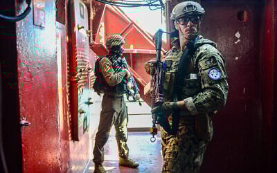 An American sailor from the US 5th Fleet (foreground) and an Israeli Navy sailor (background) pose for a photo during a joint drill off the coast of Haifa, August 7, 2023. (Israel Defense Forces)