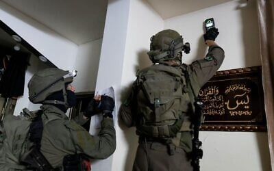 IDF combat engineering forces take measurements at the home of a Palestinian accused of carrying out a deadly shooting attack near Hebron, early August 23, 2023, (Israel Defense Forces)