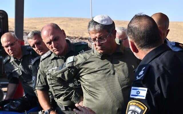 National Security Minister Itamar Ben Gvir, wearing at least a partial Border Police uniform, and Police Chief Kobi Shabtai (with his back to camera) visit a Border Police training base, August 1, 2023 (Border Police) National Security Minister Itamar Ben Gvir, wearing at least a partial Border Police uniform, and Police Chief Kobi Shabtai (with his back to camera) visit a Border Police training base, August 1, 2023 (Border Police)
