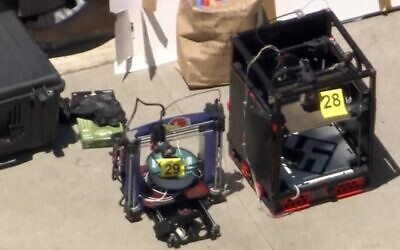 A screenshot of KTLA5 footage of 3D printers taken from Ryan Scott Bradford's home one of which is clearly emblazoned with a swastika. (YouTube screenshot/ used in accordance with Clause 27a of the Copyright Law)