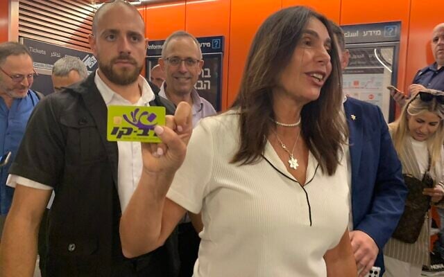 Transportation Minister Miri Regev holds up a Rav-Kav card given to her by a member of the press, before entering Allenby Station, August 16, 2023. (Charlie Summers/Times of Israel) Transportation Minister Miri Regev holds up a Rav-Kav card given to her by a member of the press, before entering Allenby Station, August 16, 2023. (Charlie Summers/Times of Israel)