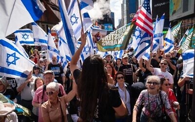 Israelis protest the judicial overhaul in New York City's Times Square as Prime Minister Benjamin Netanyahu visits the city to meet with world leaders at the UN's General Assembly, September 19, 2023. (Luke Tress/Times of Israel)