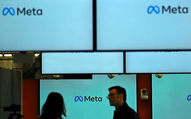 Visitors stand in front and next to screens displaying the Meta logo during a launch event at the corporate offices of Meta in Berlin on June 6, 2023. (Tobias Schwarz/AFP) Visitors stand in front and next to screens displaying the Meta logo during a launch event at the corporate offices of Meta in Berlin on June 6, 2023. (Tobias Schwarz/AFP)