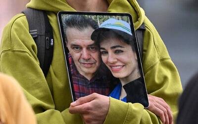 A demonstrator holds a picture of Iranian-German Jamshid Sharmahd (left), who has been sentenced to death in Iran, with his daughter Gazelle Sharmahd during a demonstration for his release in front of the German Foreign Ministry in Berlin, Germany, on July 31, 2023. (INA FASSBENDER/AFP)