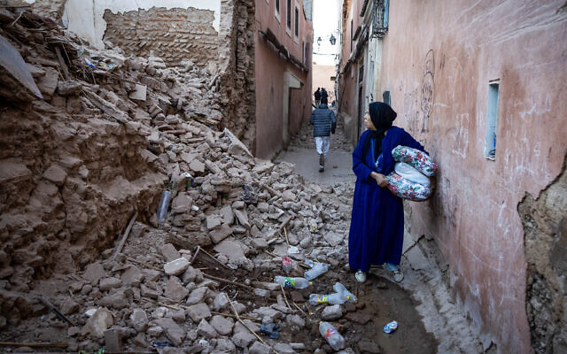 A woman looks at the rubble of a building in the earthquake-damaged old city in Marrakesh, Morocco, on September 9, 2023. (Fadel Senna/AFP) A woman looks at the rubble of a building in the earthquake-damaged old city in Marrakesh, Morocco, on September 9, 2023. (Fadel Senna/AFP)