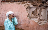 A woman reacts standing infront of her earthquake-damaged house in the old city in Marrakesh on September 9, 2023. (Photo by FADEL SENNA / AFP)
