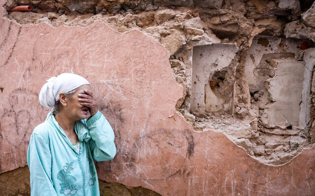 A woman reacts standing infront of her earthquake-damaged house in the old city in Marrakesh on September 9, 2023. (Photo by FADEL SENNA / AFP) A woman reacts standing infront of her earthquake-damaged house in the old city in Marrakesh on September 9, 2023. (Photo by FADEL SENNA / AFP)