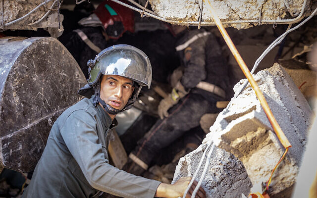 A rescuer searches for survivors under the rubble of a house destroyed in an earthquake in Moulay Brahim, Al-Haouz province, on September 9, 2023. (Fadel Senna/AFP) A rescuer searches for survivors under the rubble of a house destroyed in an earthquake in Moulay Brahim, Al-Haouz province, on September 9, 2023. (Fadel Senna/AFP)