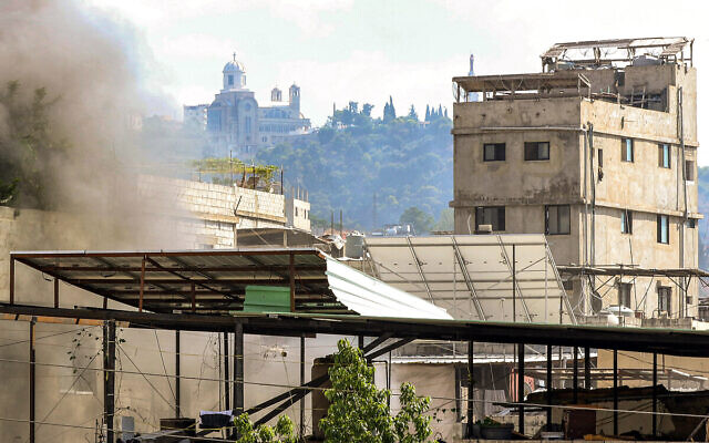 Smoke billows above buildings in the Ain al-Helweh camp for Palestinian refugees in Lebanon's southern coastal city of Sidon on September 10, 2023. (Mahmoud ZAYYAT / AFP)
