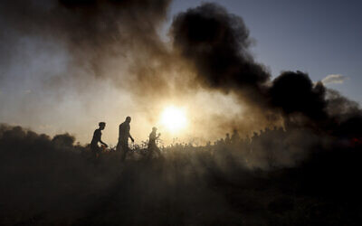 Palestinian rioters burn tires during clashes with Israeli soldiers along the Israel-Gaza border on September 15, 2023. (MOHAMMED ABED / AFP)