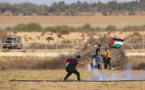 A Palestinian demonstrator throws a tear gas canister back at Israeli forces during clashes along the Israel-Gaza border, east of Khan Younis in the southern Gaza Strip on September 15, 2023. (SAID KHATIB / AFP)
