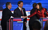 Florida Governor Ron DeSantis looks on as former Governor from South Carolina and UN ambassador Nikki Haley shakes hands with North Dakota Governor Doug Burgum following the second Republican presidential primary debate at the Ronald Reagan Presidential Library in Simi Valley, California, on September 27, 2023. (Photo by Robyn BECK / AFP)