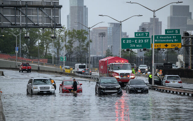 Cars in floodwater on the FDR Highway in Manhattan, New York, on September 29, 2023. (Ed Jones/AFP)