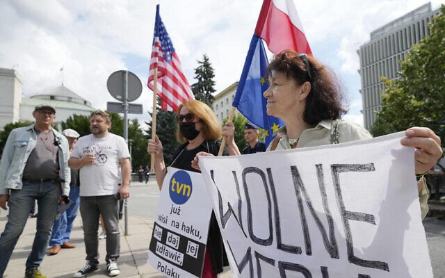 People gather outside Poland's parliament to protest the government plans to vote on a media bill seen as restricting media independence, in Warsaw, Poland, August 11, 2021. (AP Photo/Czarek Sokolowski)
