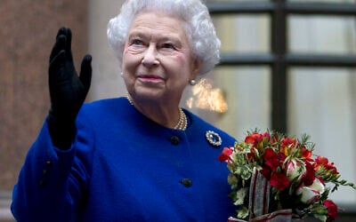 In this Tuesday, Dec. 18, 2012 file photo, Britain's Queen Elizabeth II looks up and waves to members of staff of The Foreign and Commonwealth Office as she ends an official visit which is part of her Jubilee celebrations in London. (AP/Alastair Grant Pool, File)