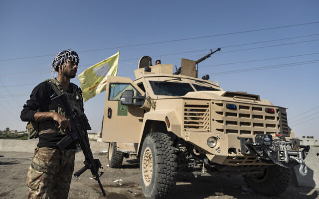 A US-backed Syrian Democratic Forces (SDF) fighter stands next an armored vehicle, at al-Sabha town in the eastern countryside of Deir el-Zour, Syria, September 4, 2023. (AP Photo/Baderkhan Ahmad) A US-backed Syrian Democratic Forces (SDF) fighter stands next an armored vehicle, at al-Sabha town in the eastern countryside of Deir el-Zour, Syria, September 4, 2023. (AP Photo/Baderkhan Ahmad)